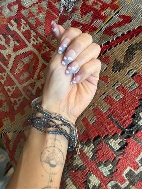 Free People iridescent blue-purple beaded bracelet with silver cross jewelry